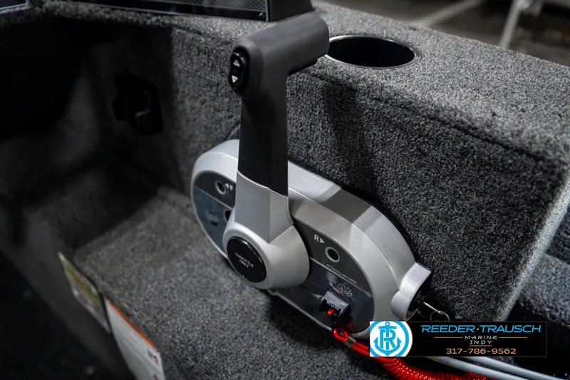 Slide: The Image of 2025 Lund 1650 Rebel XL SS boat throttle control in a carpeted interior. - 37