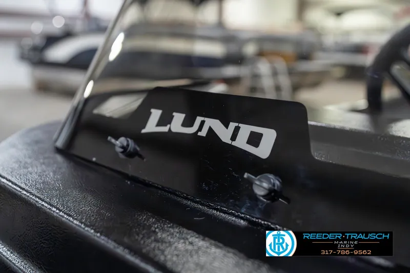 Slide: The Image of 2025 Lund 1650 Rebel XL SS boat windshield with logo in showroom. - 40