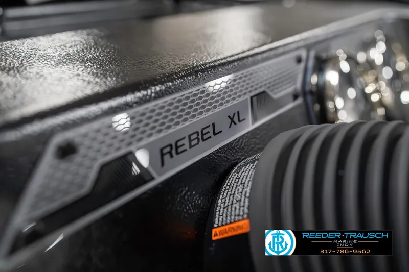 Slide: The Image of 2025 Lund 1650 Rebel XL SS boat dashboard close-up with branding details. - 41