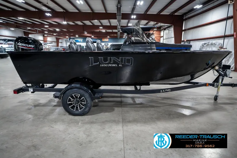 Slide: The Image of 2025 Lund 1650 Rebel XL SS boat on trailer in indoor showroom. - 5