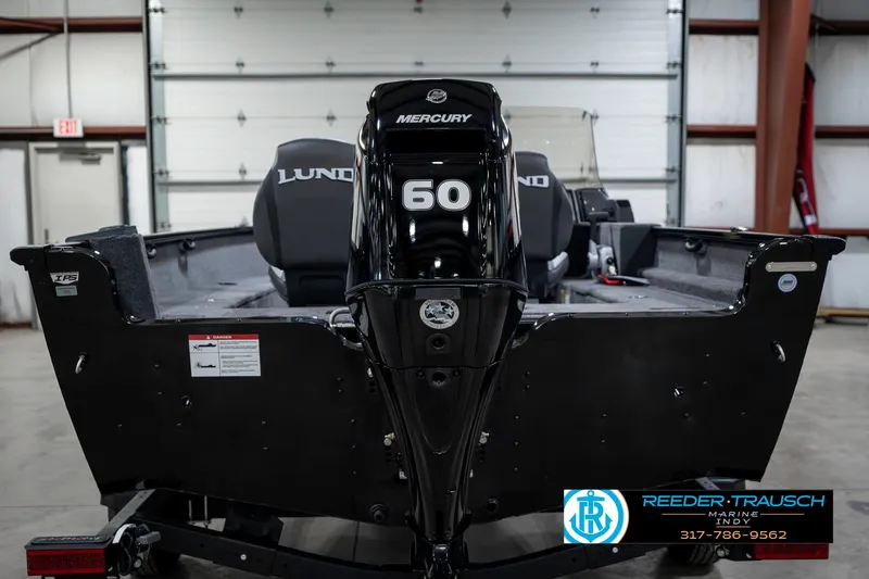 Slide: The Image of 2025 Lund 1650 Rebel XL SS boat with Mercury 60 engine in a garage. - 7
