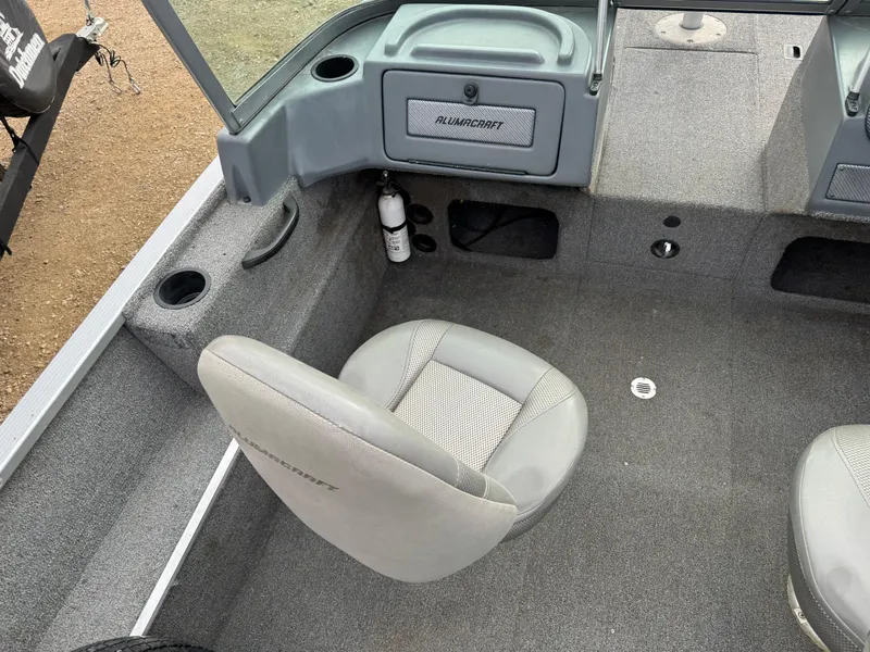 Slide: The Image of 2012 Alumacraft 165 Competitor boat interior with gray seating and storage compartments. - 10