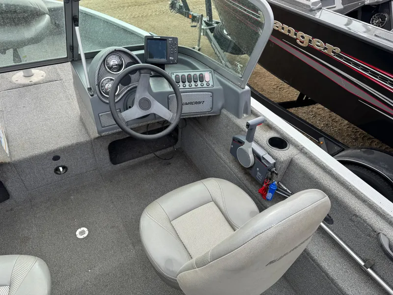 Slide: The Image of 2012 Alumacraft 165 Competitor boat interior with steering wheel and control panel. - 11