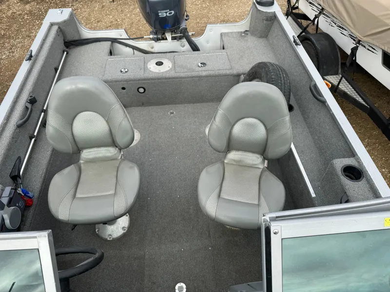 Slide: The Image of 2012 Alumacraft 165 Competitor boat interior with two gray seats and motor. - 5
