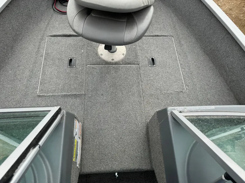 Slide: The Image of 2012 Alumacraft 165 Competitor boat interior with gray carpet and swivel seat. - 8