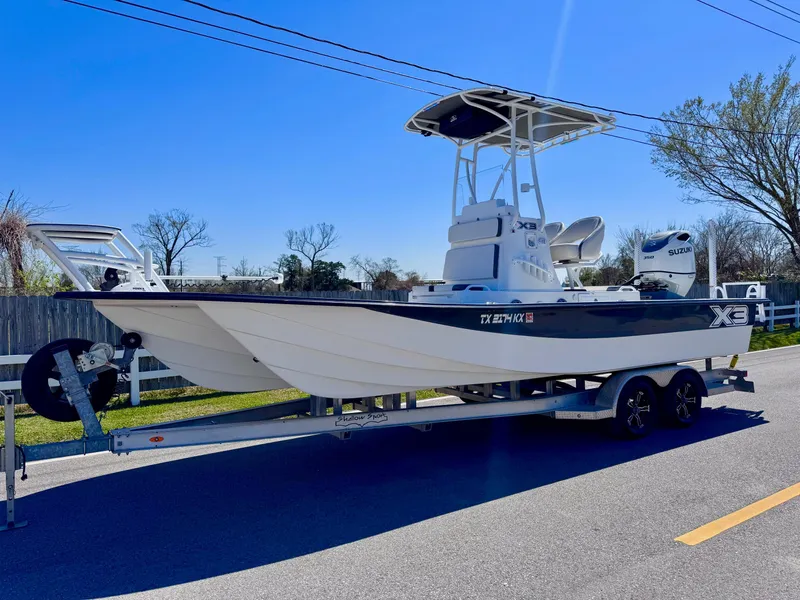 Slide: The Image of 2024 Shallow Sport 25 X3 boat on trailer, sunny day, clear blue sky. - 1