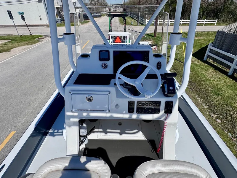 Slide: The Image of 2024 Shallow Sport 25 X3 boat console with steering wheel and controls. - 10