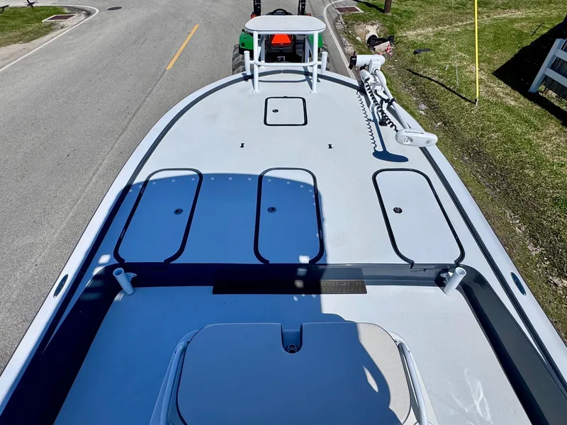 Slide: The Image of 2024 Shallow Sport 25 X3 boat on trailer, top view, parked on roadside. - 12