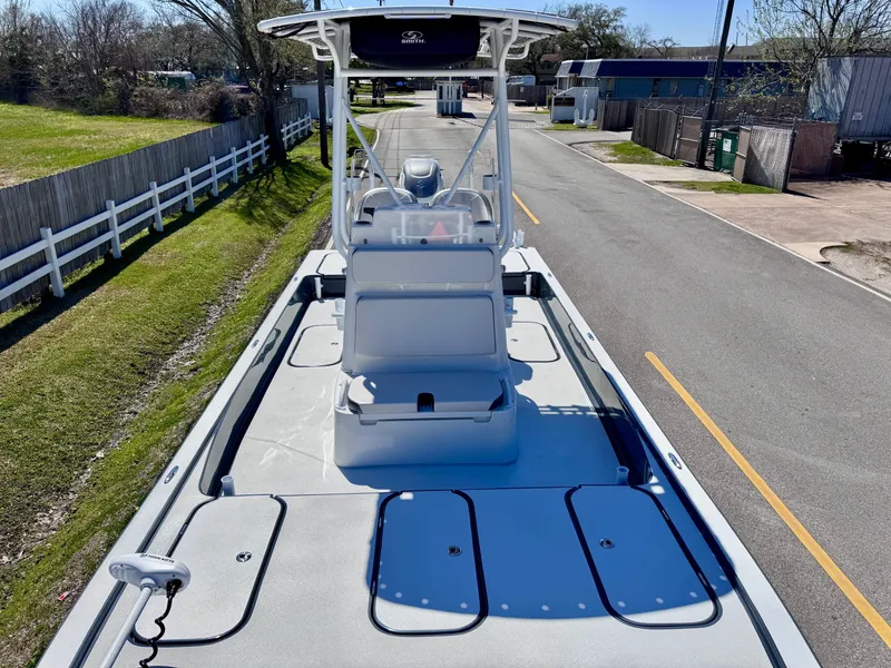 Slide: The Image of 2024 Shallow Sport 25 X3 boat on a road, showcasing deck and seating. - 14