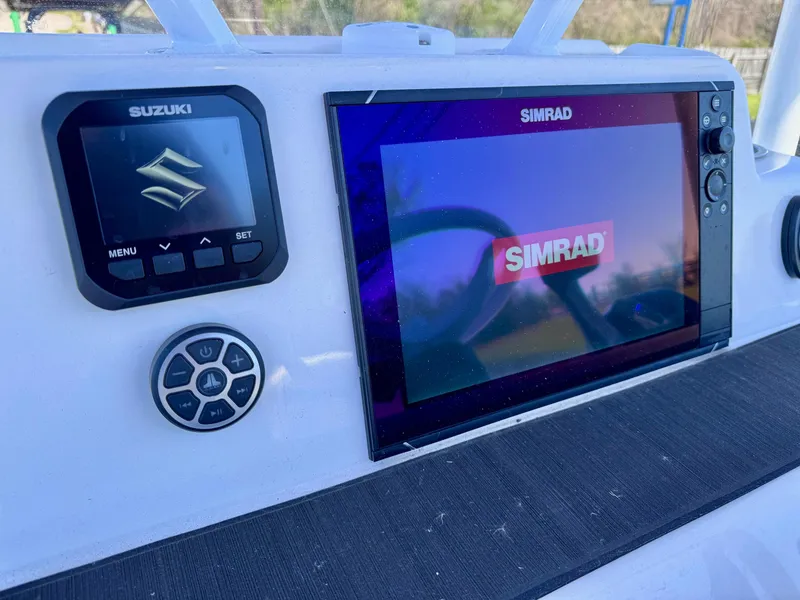 Slide: The Image of 2024 Shallow Sport 25 X3 boat dashboard with Suzuki and Simrad displays. - 15