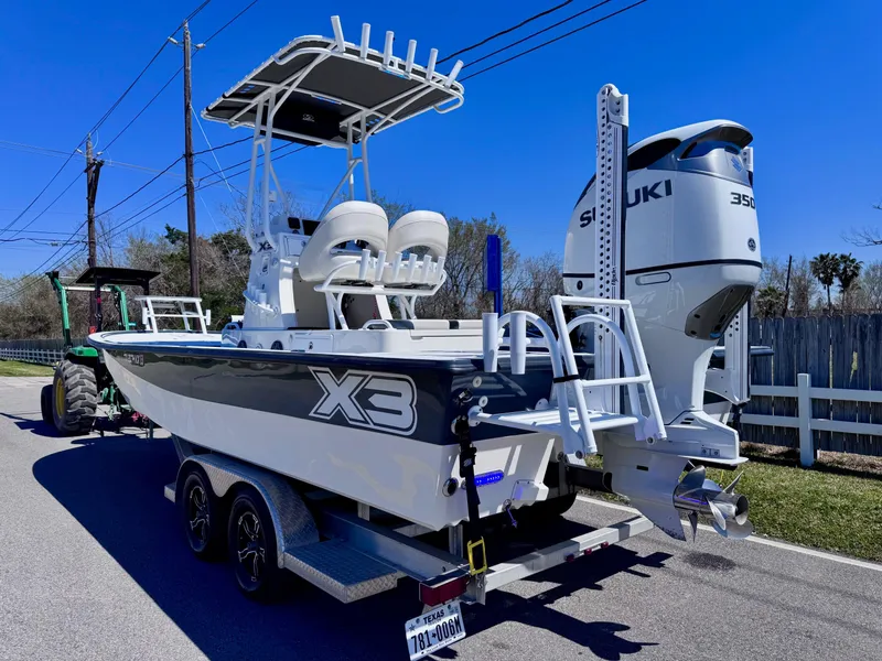 Slide: The Image of 2024 Shallow Sport 25 X3 boat on trailer with Suzuki 350 engine. - 2