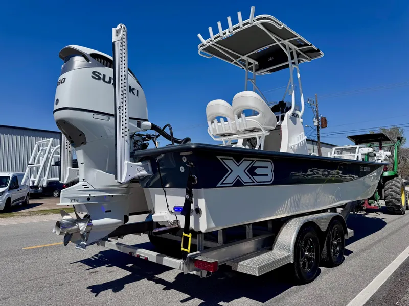 Slide: The Image of 2024 Shallow Sport 25 X3 boat on trailer with Suzuki outboard motor. - 4