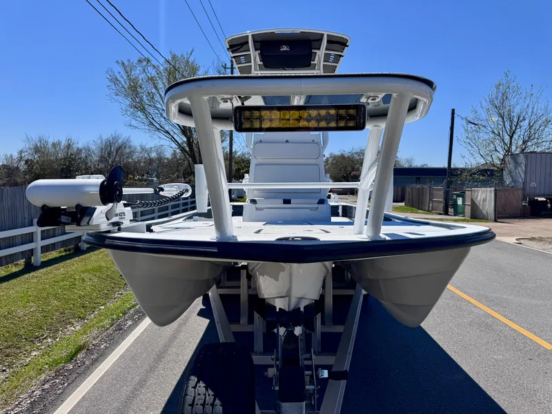Slide: The Image of 2024 Shallow Sport 25 X3 boat on trailer, viewed from the front on a sunny day. - 6