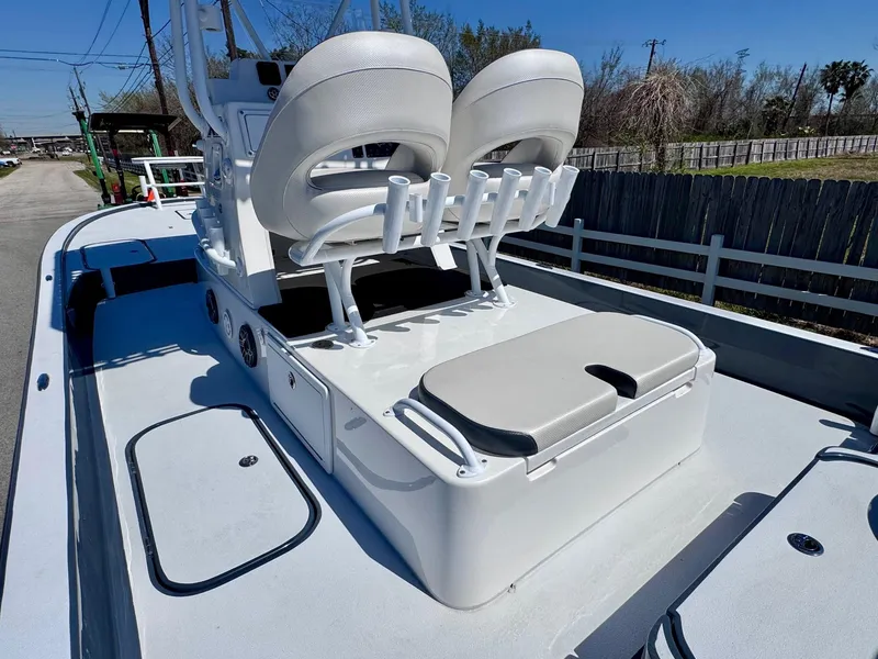 Slide: The Image of 2024 Shallow Sport 25 X3 boat interior with seating and rod holders. - 8