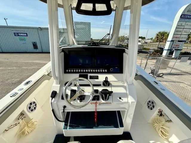 Slide: The Image of 2023 Regulator 28 boat cockpit with steering wheel and control panel. - 11