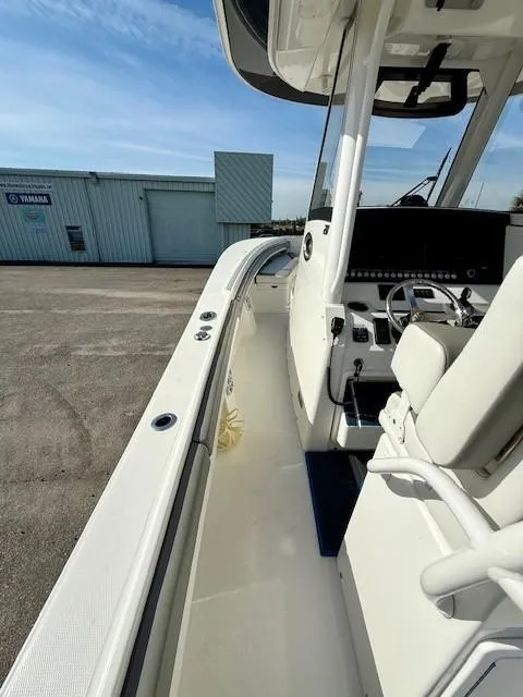 Slide: The Image of 2023 Regulator 28 boat, side view, showcasing sleek design and modern controls. - 14