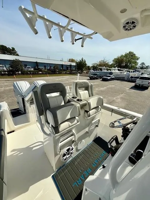 Slide: The Image of 2023 Regulator 28 boat interior with dual seats and rod holders. - 15