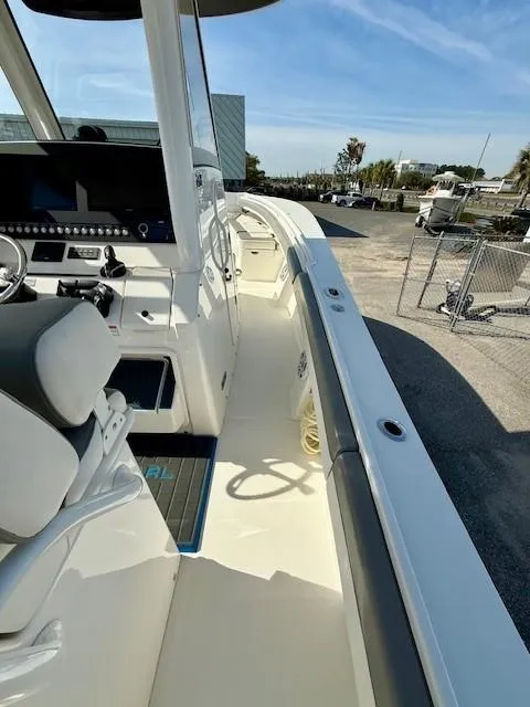 Slide: The Image of 2023 Regulator 28 boat interior with helm, seating, and open deck view. - 16