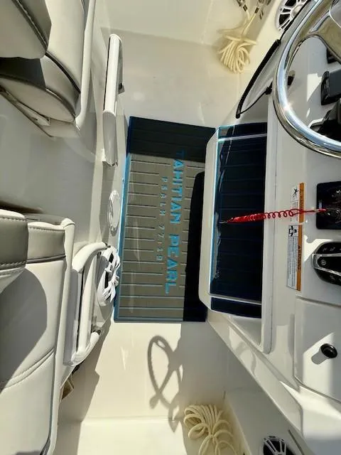 Slide: The Image of 2023 Regulator 28 boat interior with steering wheel and seating. - 17
