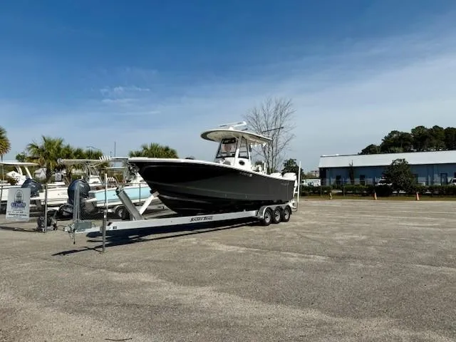 Slide: The Image of 2023 Regulator 28 boat on a trailer in a parking lot under a clear blue sky. - 2