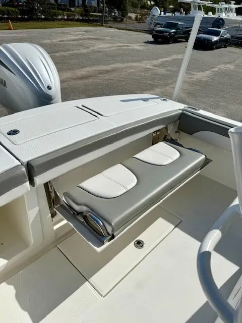 Slide: The Image of 2023 Regulator 28 boat with foldable seating and Yamaha engine in a marina setting. - 21