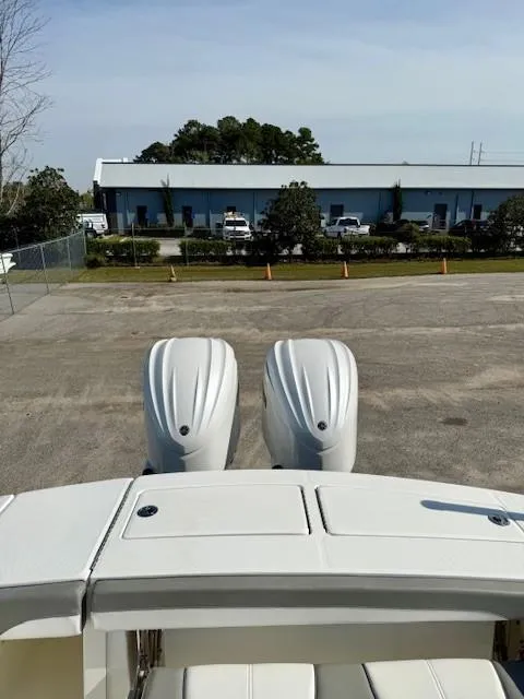 Slide: The Image of 2023 Regulator 28 boat with dual engines in a parking lot. - 22
