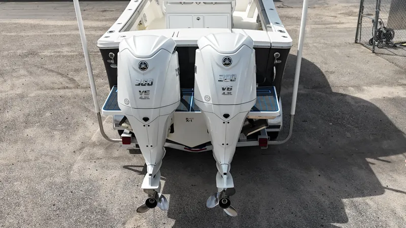 Slide: The Image of 2023 Regulator 28 boat with twin Yamaha V6 outboard engines, rear view. - 25