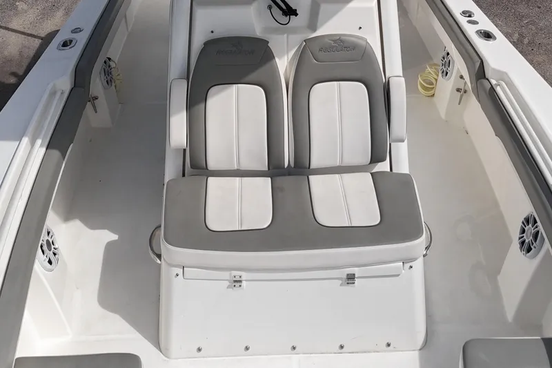 Slide: The Image of 2023 Regulator 28 boat interior with dual cushioned seats. - 29