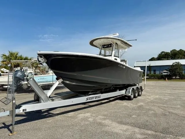 Slide: The Image of 2023 Regulator 28 boat on trailer in parking lot, clear sky background. - 5