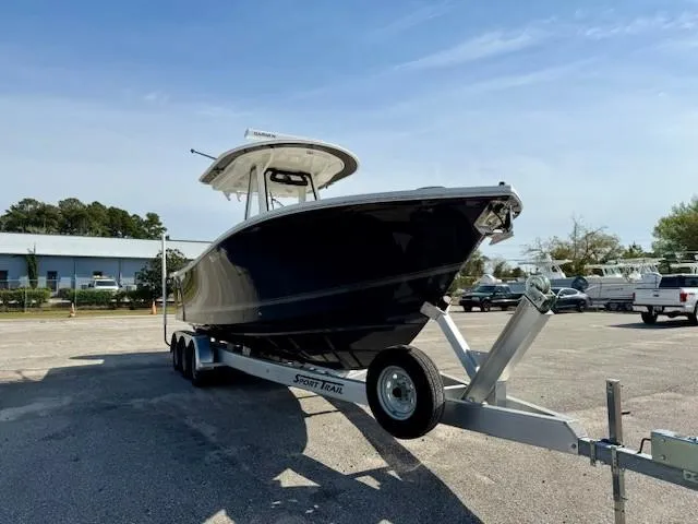 Slide: The Image of 2023 Regulator 28 boat on trailer in sunny parking lot. - 6