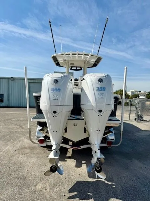 Slide: The Image of 2023 Regulator 28 boat with twin 300 horsepower engines, docked outdoors. - 8