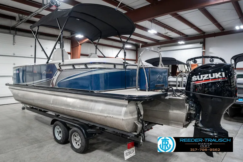 Slide: The Image of 2020 Avalon 2485 pontoon boat with Suzuki outboard motor in a showroom. - 10