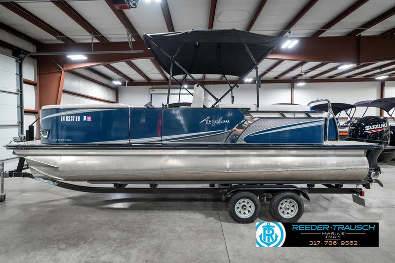 Slide: The Image of 2020 Avalon 2485 pontoon boat with canopy in indoor storage facility. - 11
