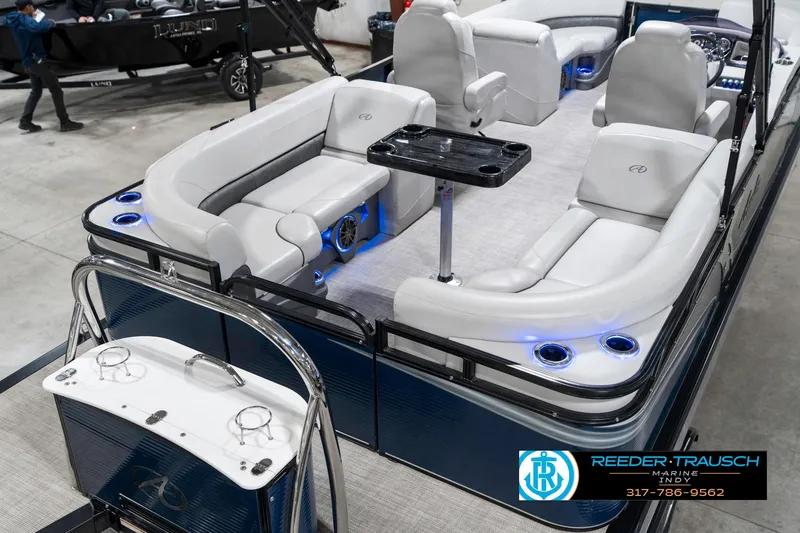 Slide: The Image of 2020 Avalon 2485 pontoon boat with luxurious seating and blue LED lighting in showroom. - 14