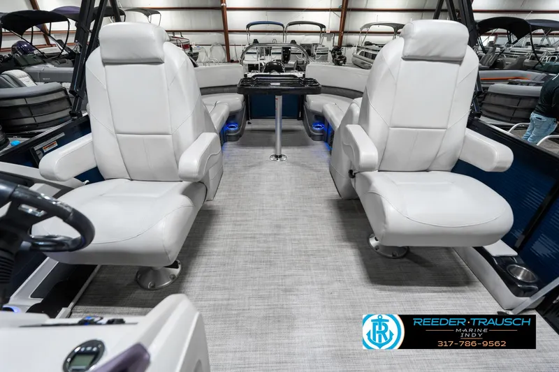 Slide: The Image of Interior of a 2020 Avalon 2485 boat with two white captain chairs. - 17