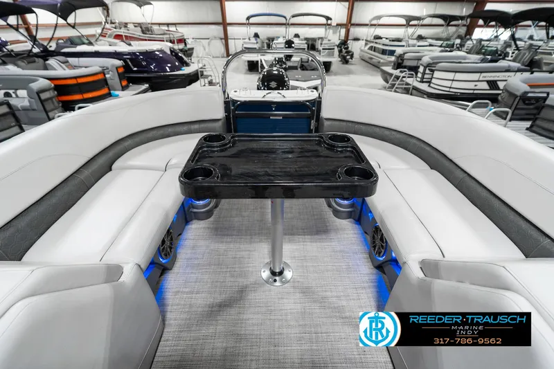 Slide: The Image of 2020 Avalon 2485 pontoon boat interior with seating and table, displayed in showroom. - 18