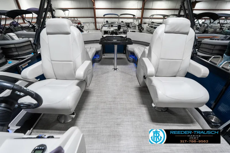 Slide: The Image of 2020 Avalon 2485 boat interior with plush white seating and modern dashboard. - 20