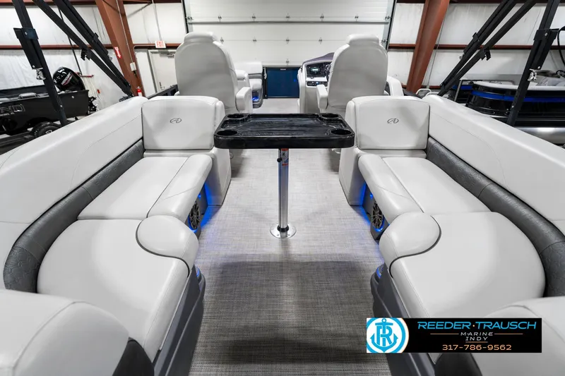Slide: The Image of 2020 Avalon 2485 boat interior with gray seating and central table in showroom. - 21