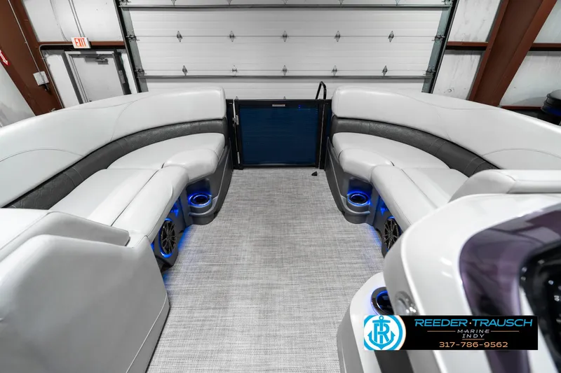Slide: The Image of 2020 Avalon 2485 boat interior with plush seating and blue LED lighting. - 23