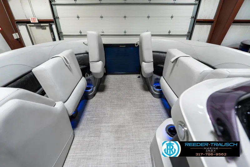 Slide: The Image of Interior of a 2020 Avalon 2485 boat with plush seating and blue accent lighting. - 24