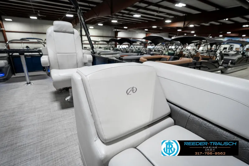 Slide: The Image of 2020 Avalon 2485 boat interior with luxurious seating in a showroom. - 25