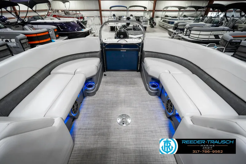 Slide: The Image of 2020 Avalon 2485 boat interior with gray seating and blue lighting in showroom. - 28