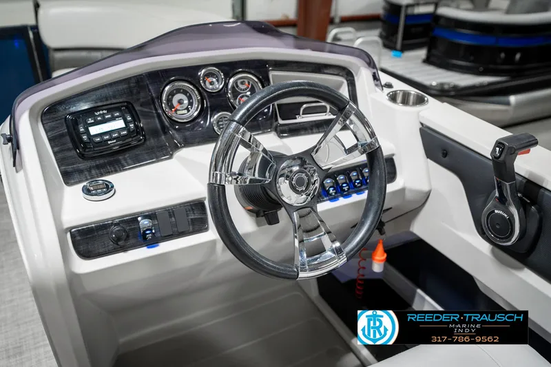 Slide: The Image of Steering console of a 2020 Avalon 2485 boat with modern controls and gauges. - 31