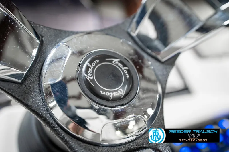 Slide: The Image of Steering wheel of a 2020 Avalon 2485 boat, featuring chrome accents and branding. - 32