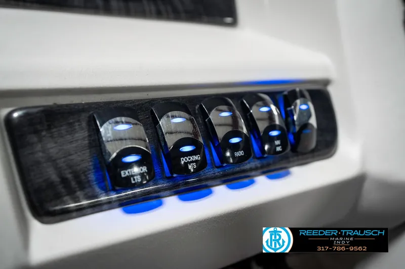 Slide: The Image of Control panel of 2020 Avalon 2485 boat with illuminated switches. - 38