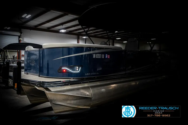 Slide: The Image of 2020 Avalon 2485 pontoon boat in a dimly lit indoor setting. - 4