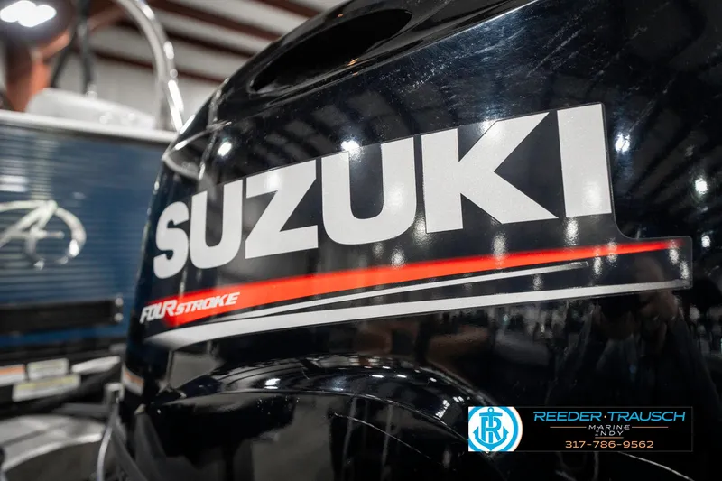 Slide: The Image of Suzuki four-stroke engine on 2020 Avalon 2485 boat, indoor setting. - 48