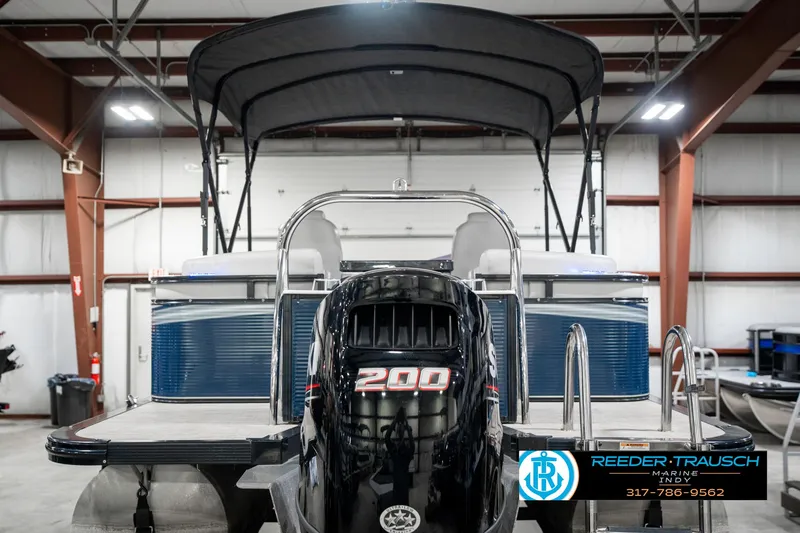Slide: The Image of 2020 Avalon 2485 pontoon boat with 200 HP engine in a showroom. - 9