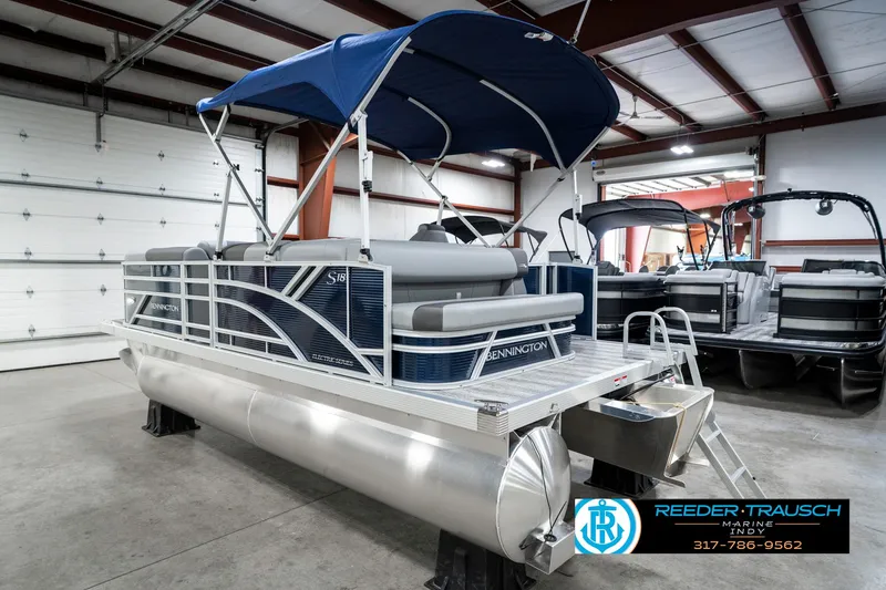 Slide: The Image of 2025 Bennington 18 SLJ pontoon boat with blue canopy in showroom. - 10