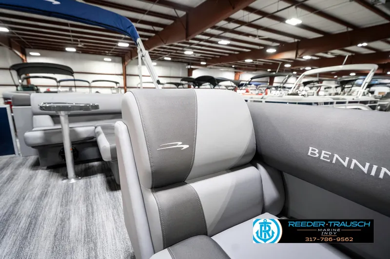 Slide: The Image of 2025 Bennington 18 SLJ boat interior with gray seating in showroom. - 23